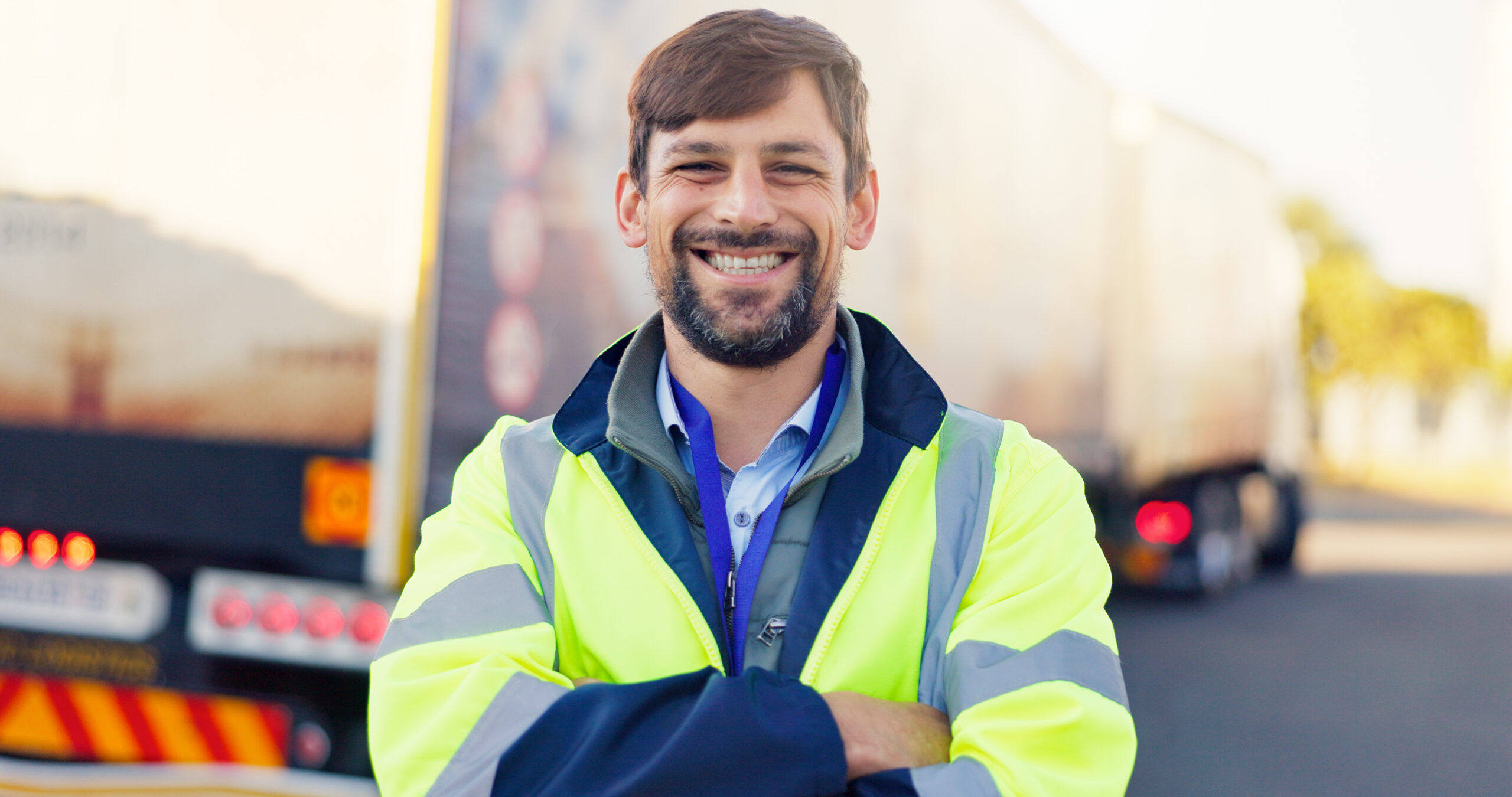 Transport manager standing beside a goods vehicle